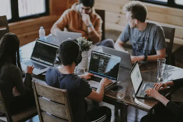 Software development team collaborating and applauding during a workshop